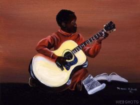 young boy playing guitar